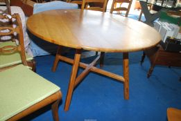 An Ercol style drop leaf dining table, approx. 44" x 49" (raised leaves) x 28 1/2" high.