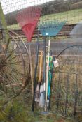 A quantity of mixed garden tools including; rakes, spades, etc.
