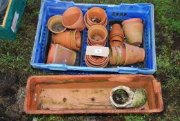 A long terracotta planter a/f (28" x 8"), a boot and various sized clay pots.