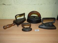 A group of four Irons including Kenrick & Sons 'Mrs Potts' style Box Iron (1919-1926) in ovular