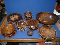 A large oval treen Bowl and dishes to match, ten in total,