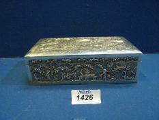 An Eastern silver coloured cigarette box having finely detailed panels depicting oriental scenes