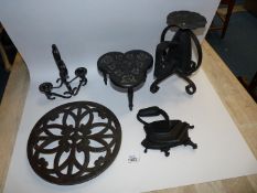 A small quantity of cast iron including a circular trivet and 'clover' shape trivets and a Pricket