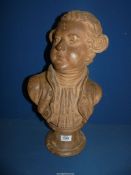 A sculpted Terracotta Bust of a gentleman wearing a doublet and a scarf and with early Georgian