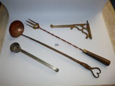 A Horlicks measuring scoop with holes, a copper and metal ladle, toasting fork with brass tongs,