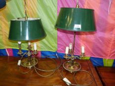 A pair of Bouillotte table Lamps with three brass candle effect light and green metal shades,