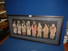 A framed Collage depicting eight oriental mortal figures depicted in fabric,