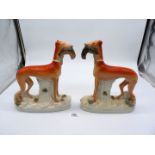 A large and impressive pair of Staffordshire standing greyhounds, c.