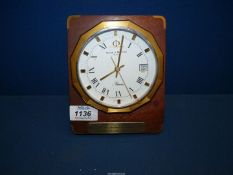 A Baume & Mercier Riviera desk clock on wooden plinth with presentation plaque.