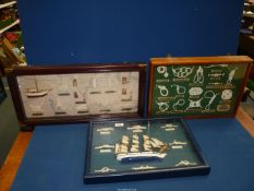 Three box frames containing nautical knot work, cleats, winches and model boats.