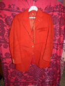 A red wool Hunting Jacket, with two brass monogram buttons,