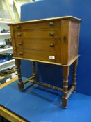 A very attractive dark wood specimen Chest of four drawers having columned and braced legs,