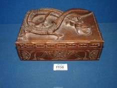 A carved box with dragon detail to the lid,