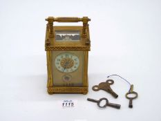 A small French travel clock c. 1880 with alarm and pierced decoration to the dials.