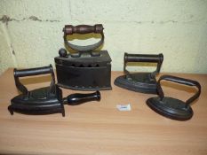 A group of four Irons including a wooden handled Coal Iron, WM Cross est.