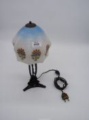 A 1940s (?) art deco style wrought iron table lamp with a frosted and transfer printed glass shade.