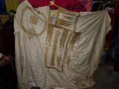 A cream robe/Kaftan with gold embroidery, possibly a wedding coat or church robe.