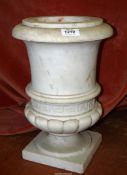 A heavy marble jardiniere/urn having a square base with ribbed bottom, white with flecks of grey,