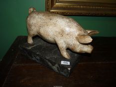 An appealing carved wood depiction of a Pig, with curled tail,
