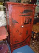 A Cinabar coloured lacquered oriental Cupboard illustrated with pavilion scenes, figures in gardens,