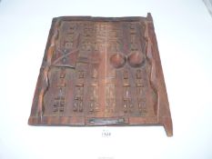A vintage African Dogon small door for a grain store, well carved and with old metal fittings,