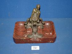 A bronze Figure of a man fighting a beast, on a marble stand possibly an ink and pen stand,