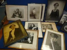 A quantity of framed black and white Portraits.