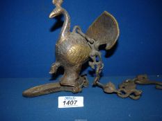 A heavy metal hanging Oriental oil lamp in the shape of a Peacock.