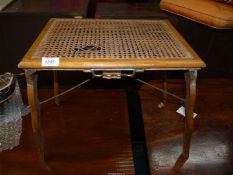 An unusual Beech framed cane seated folding Stool with patent action,