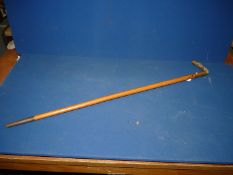 A lightwood Walking Stick having a brass and jade handle with the initials GJK on one side and TW