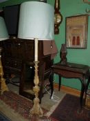 A shabby chic formerly gilt wood based floor/standard Lamp having a triple scroll footed base and