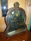 A shaped black lacqured chinoiserie wall hanging Mirror decorated in gold with trailing ivy and