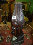 A heavy carved Burmese hardwood Bust with unusual tall hairstyle,