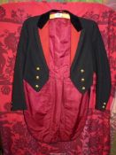A cooling Lawrence & Sons black woolen tailcoat with velvet collar and red lining having monogram