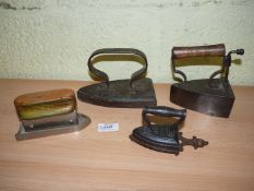 A group of four Irons including a very small J. & J. Siddons No.