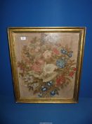 A gilded framed well worked Tapestry of an arrangement of flowers, some repair,