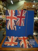 Four mixed size vintage Union Jack Flags in rayon and linen with wooden cases and two baseball caps,