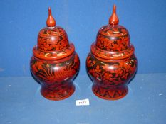 A pair of highly polished Burmese black and terracotta lacquered Urns, 11" tall.