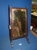 A Mahogany swing Mirror, 12" x 24" tall.