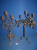 Two wrought iron candelabras, one having five branches with ivy leaf design,