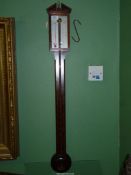 A stick Barometer by Comitti and Sons London in Mahogany and boxwood having broken arch design