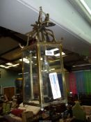 A hexagonal six pane Brass framed Hall Lantern light fitting with hanging rose and bulb,