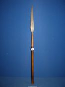 A spear with rope bound blade and wooden handle.