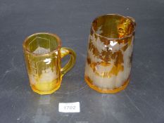 *** Two amber glass Tankards, the smaller one being Waisbaden, the larger one a/f.