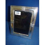 A modern Silver photograph frame with hammered design, '0999' stamped to the top,
