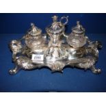 An ornate silver plated Inkwell stand with two glass pots and a central candle holder, a/f.