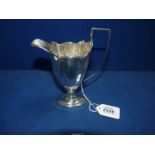 A Silver helmet shaped cream jug, London 1902, 162g.