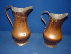 Two copper Jugs, 10 1/2" and 11 1/2" tall.
