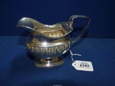 A Dutch Silver cream Jug having a lion rampant in shield and letter 'A' stamped to base, maker E&R,