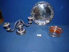 An Arthur Price plated tray (10" diameter), a pierced bottle coaster and a two branch candelabra.